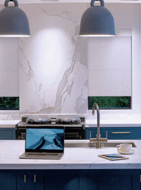 A modern kitchen with contemporary pendant lighting