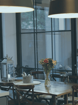 A contemporary dining space illuminated by a curated pendant light