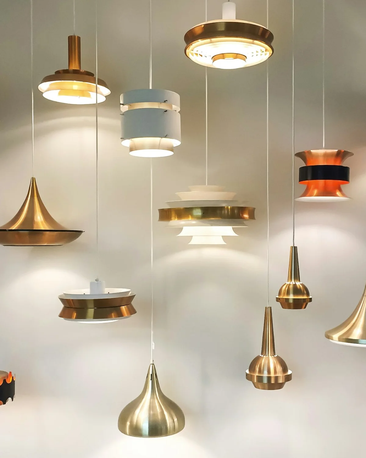 A curated group of warm brass pendant lights